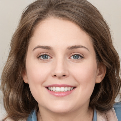 Joyful white young-adult female with medium  brown hair and blue eyes