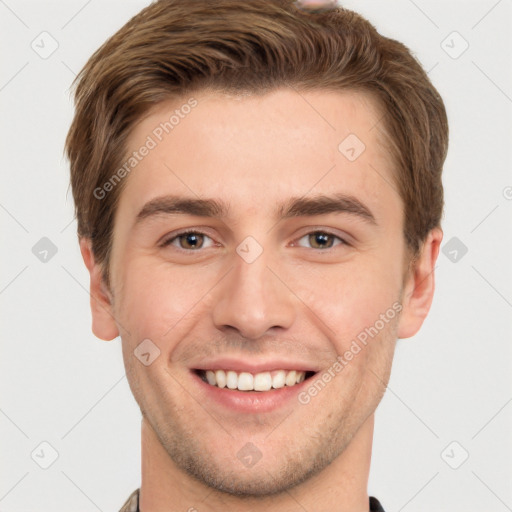 Joyful white young-adult male with short  brown hair and grey eyes