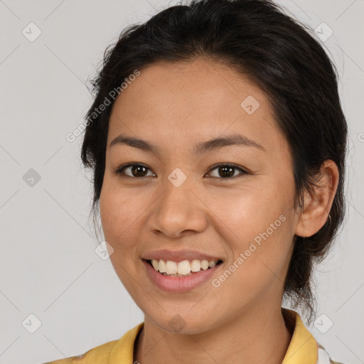 Joyful latino young-adult female with medium  brown hair and brown eyes