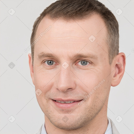 Joyful white adult male with short  brown hair and grey eyes