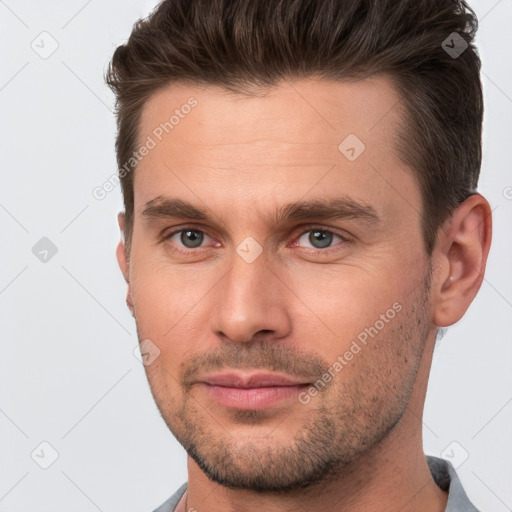 Joyful white young-adult male with short  brown hair and brown eyes