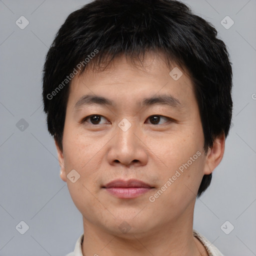 Joyful asian young-adult male with short  brown hair and brown eyes