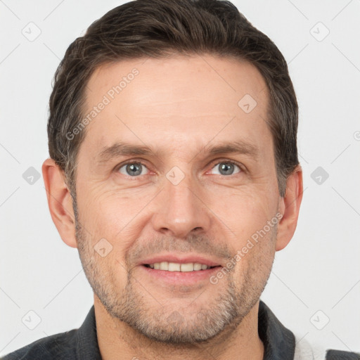 Joyful white adult male with short  brown hair and grey eyes