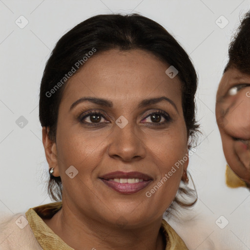 Joyful black adult female with medium  brown hair and brown eyes