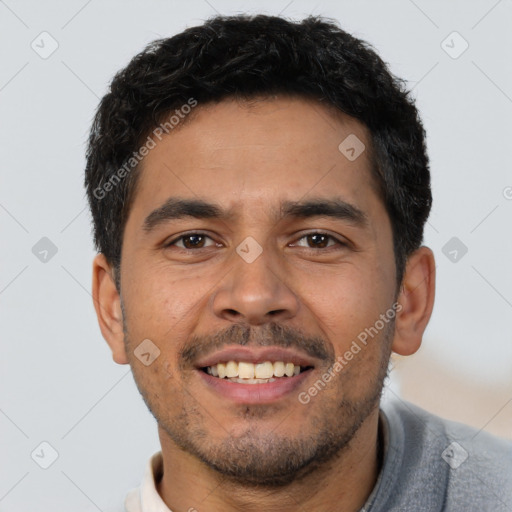 Joyful latino young-adult male with short  black hair and brown eyes