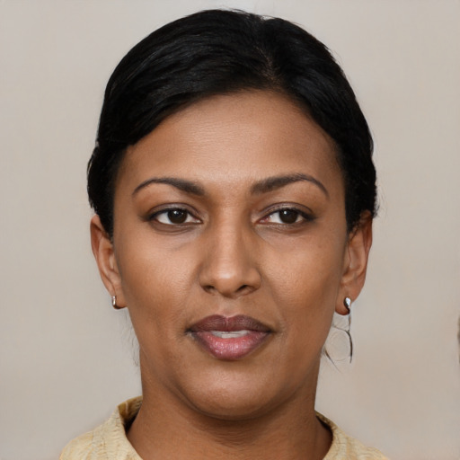 Joyful latino young-adult female with short  black hair and brown eyes