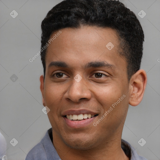 Joyful latino young-adult male with short  brown hair and brown eyes