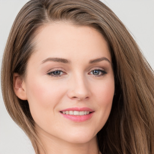 Joyful white young-adult female with long  brown hair and grey eyes