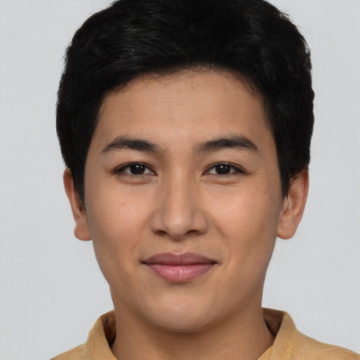 Joyful asian young-adult male with short  brown hair and brown eyes