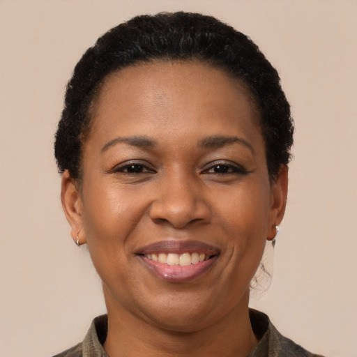Joyful black adult female with short  black hair and brown eyes