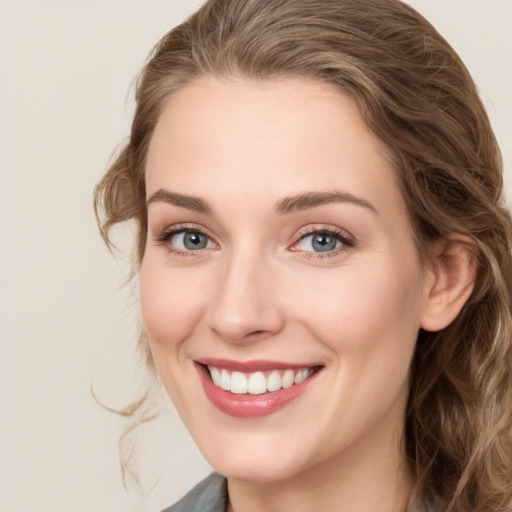 Joyful white young-adult female with medium  brown hair and blue eyes