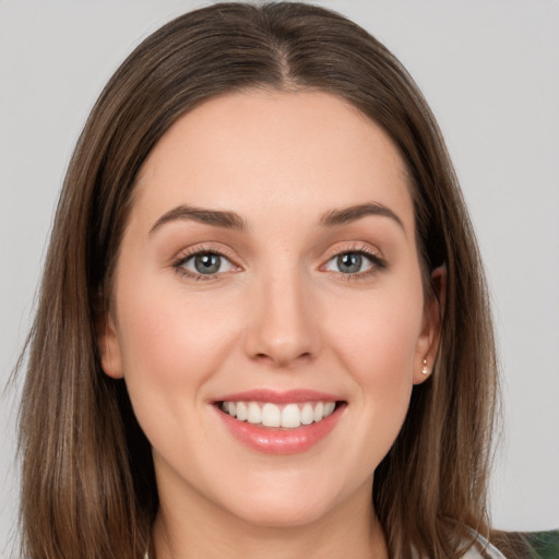 Joyful white young-adult female with long  brown hair and grey eyes