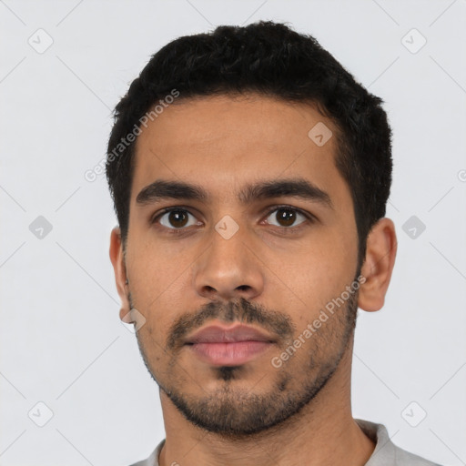 Neutral latino young-adult male with short  black hair and brown eyes