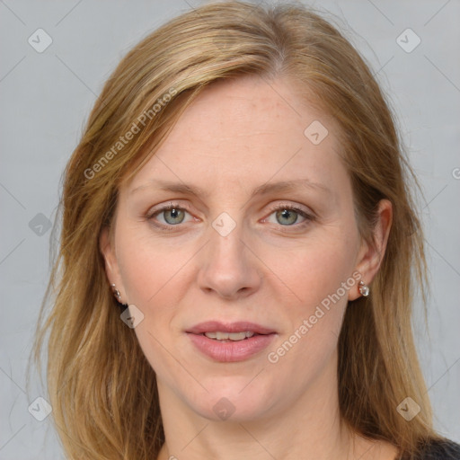 Joyful white adult female with medium  brown hair and blue eyes