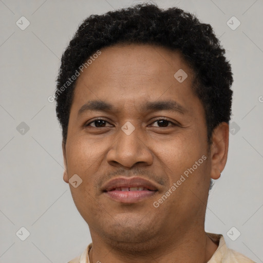 Joyful latino adult male with short  black hair and brown eyes