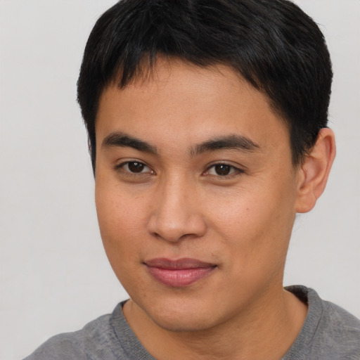 Joyful asian young-adult male with short  brown hair and brown eyes