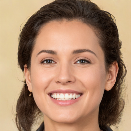 Joyful white young-adult female with medium  brown hair and brown eyes