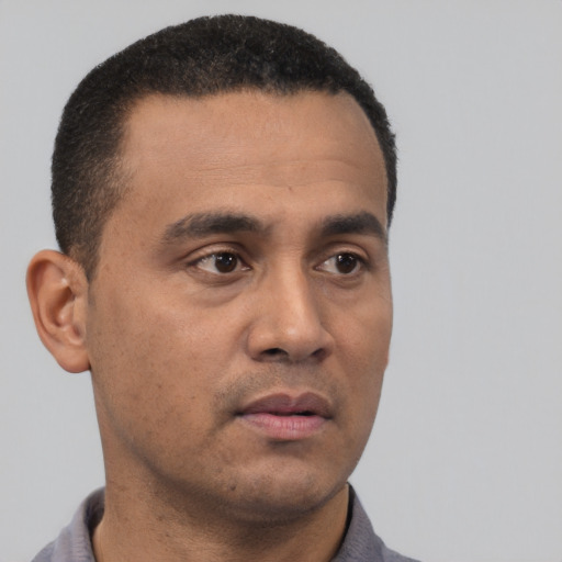 Neutral latino young-adult male with short  black hair and brown eyes