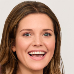 Joyful white young-adult female with long  brown hair and blue eyes