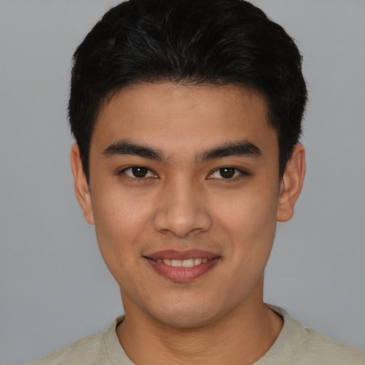 Joyful latino young-adult male with short  black hair and brown eyes