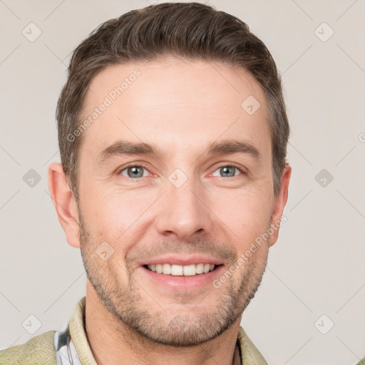 Joyful white young-adult male with short  brown hair and grey eyes