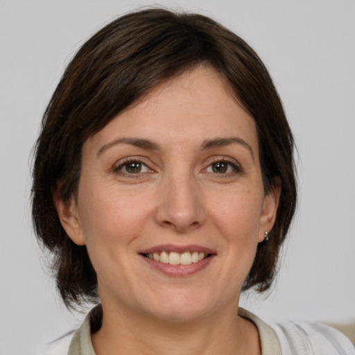 Joyful white adult female with medium  brown hair and brown eyes