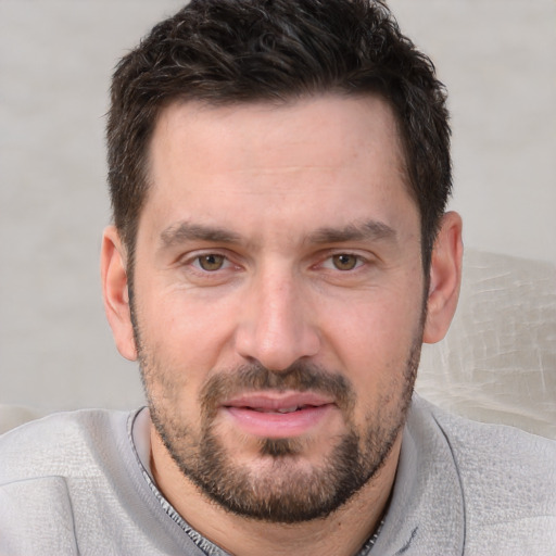 Joyful white adult male with short  brown hair and brown eyes