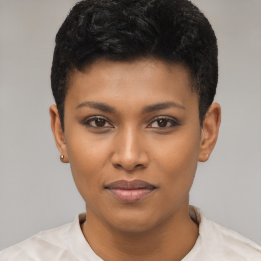 Joyful black young-adult female with short  black hair and brown eyes