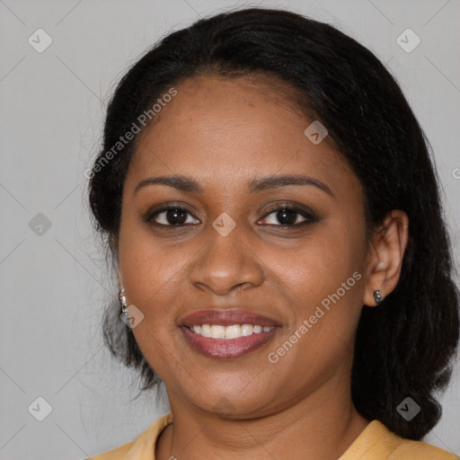 Joyful black young-adult female with long  black hair and brown eyes
