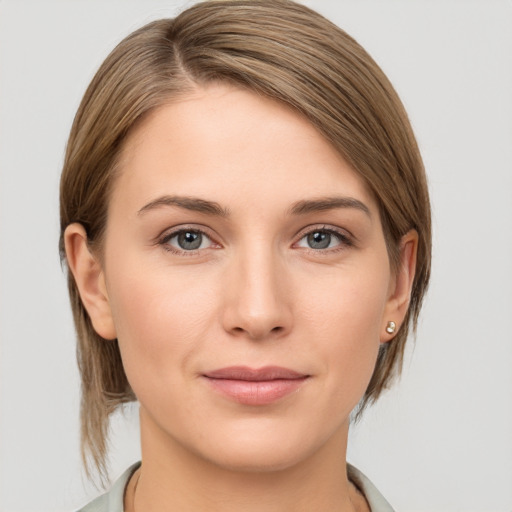 Joyful white young-adult female with medium  brown hair and grey eyes