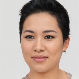 Joyful asian young-adult female with short  black hair and brown eyes