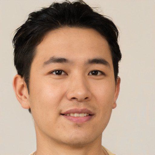 Joyful asian young-adult male with short  black hair and brown eyes