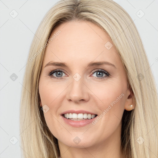 Joyful white young-adult female with long  brown hair and green eyes