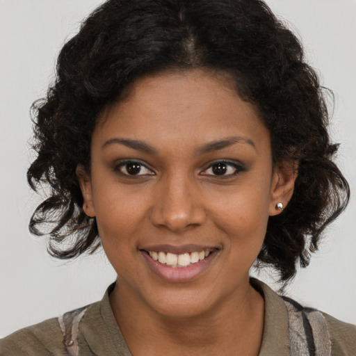 Joyful black young-adult female with medium  brown hair and brown eyes