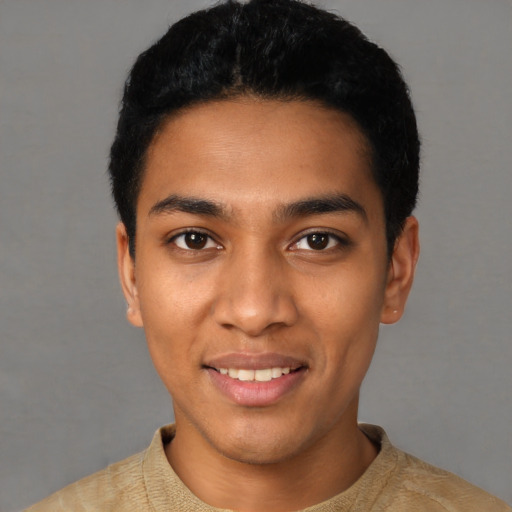 Joyful latino young-adult male with short  black hair and brown eyes