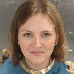 Joyful white adult female with medium  brown hair and blue eyes