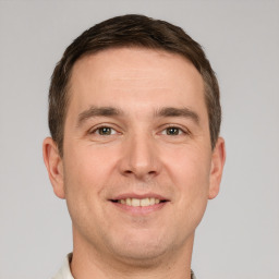 Joyful white adult male with short  brown hair and brown eyes