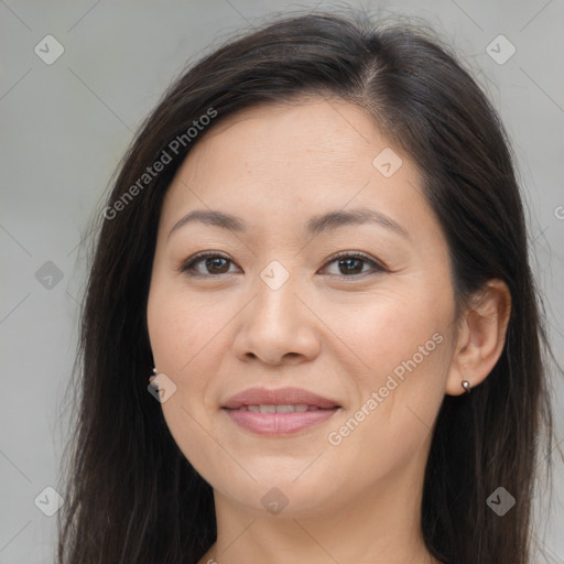 Joyful asian young-adult female with long  brown hair and brown eyes