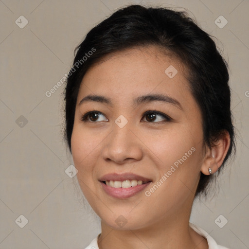 Joyful asian young-adult female with medium  brown hair and brown eyes