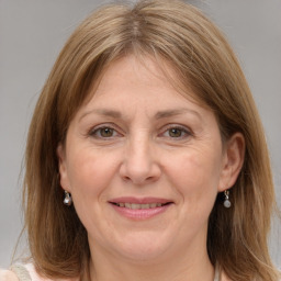 Joyful white adult female with medium  brown hair and grey eyes