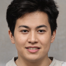 Joyful asian young-adult male with short  brown hair and brown eyes