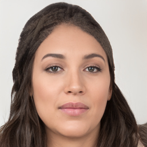 Joyful white young-adult female with long  brown hair and brown eyes