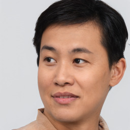 Joyful asian young-adult male with short  black hair and brown eyes