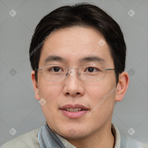 Joyful asian adult male with short  brown hair and brown eyes