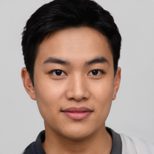 Joyful asian young-adult male with short  black hair and brown eyes