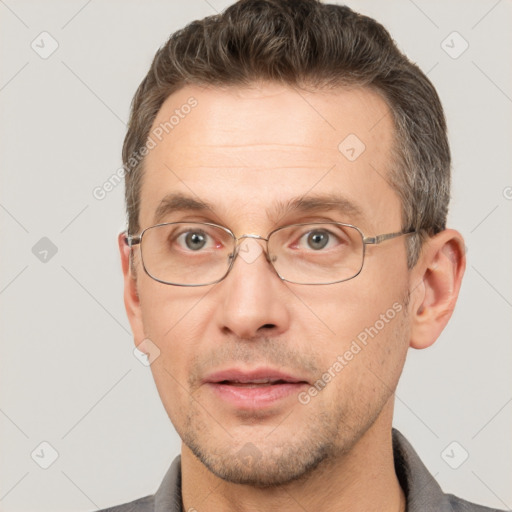 Joyful white adult male with short  brown hair and brown eyes