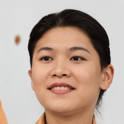 Joyful asian young-adult female with short  brown hair and brown eyes