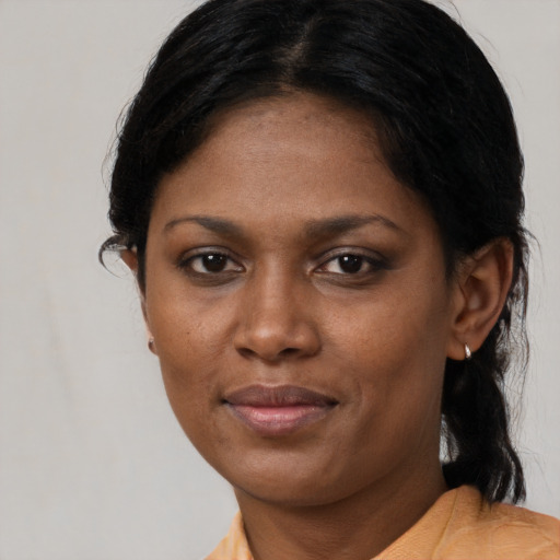 Joyful black young-adult female with medium  brown hair and brown eyes
