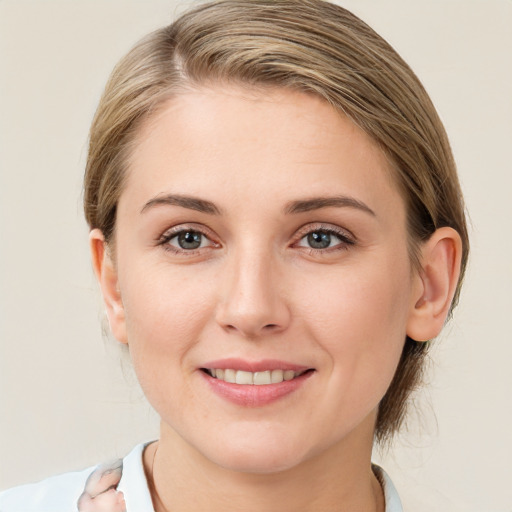 Joyful white young-adult female with medium  brown hair and blue eyes