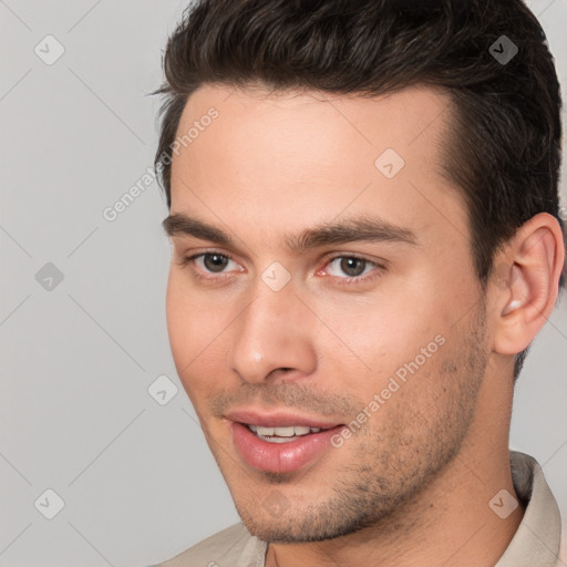 Joyful white young-adult male with short  brown hair and brown eyes